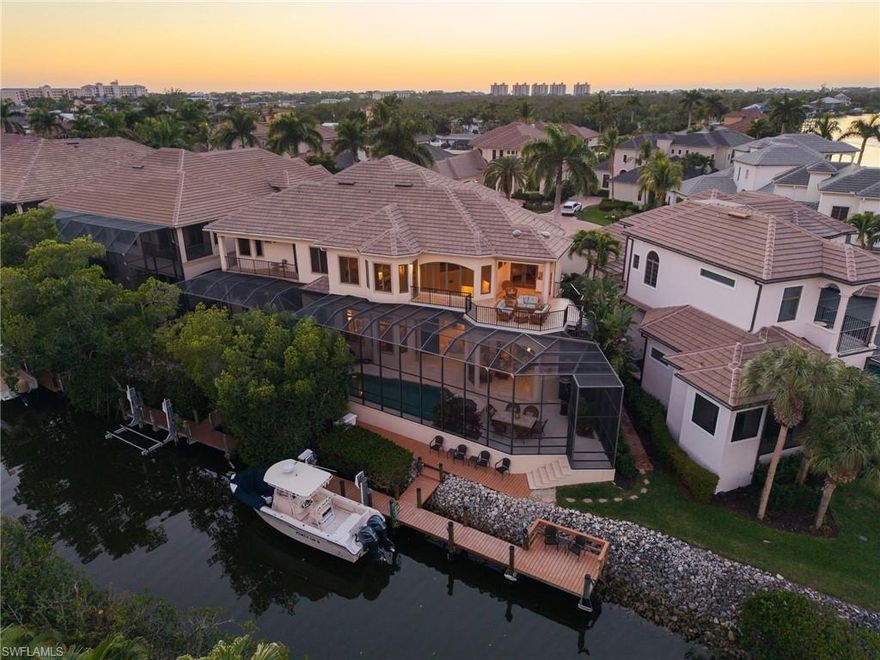 Beautifully renovated, coastal contemporary home, in a peaceful & private gated enclave with spectacular views of the Imperial River, boating Gulf-access & a 5-minute drive to the beach! HIGH & DRY DURING HURRICANE HELENE & MILTON WITH NO WATER INTRUSION! This approximately 3,600+ sq ft, light, bright & coastal home is nestled just off the Imperial River with stunning water views of dolphins splashing & boats sailing by to the Gulf. Ideal for both beach lovers & boating enthusiasts, this home is just 5 minutes away from Barefoot Beach/Bonita Beach & offers easy Gulf access through Wiggins Pass or New Pass from your 7,500 lb. boat lift with an oversized extended dock including a fishing pier space & room for jet skis or a second small boat*. Every detail is meticulously crafted from the beautifully renovated coastal contemporary kitchen & dramatic great room with soaring 2-story lofted ceilings to the gorgeous tile & white oak wood floors & modernized pool deck/patio with premium travertine pavers & new railings. Built like a fortress, this home offers all concrete construction, 2023 NEW ROOF, hurricane impact windows/sliders, 2021 A/Cs, private elevator & a built-in generator with natural gas. Features an INCREDIBLE 4 bed + den, 4.5 bath floor plan with primary suite & all main living spaces on first floor and separate guest spaces upstairs including 3 guest bedrooms (one of which could be a bonus room & one of which is a 2nd primary suite) & its own private 2nd story balcony with wet bar, beverage center, electric storm shutters & stunning water views. The newly renovated chef’s kitchen offers stunning white quartz countertops, white cabinetry, gas range & adjacent bar with wine cooler. Relax and unwind on the approximately 1520 sq ft pool deck with pool nearly twice the size of the average villa home, spa & covered seating area with grill & fireplace, all overlooking the canal & river beyond. Beautifully designer furnished (furnishings negotiable)!  River Reach Estates offers easy maintenance with the lawn care, pool care, mangrove trimming, maintenance of irrigation systems & paint reserves all covered by the HOA! Excellent location near many excellent local restaurants & close to Mercato & the Promenade, with Waterside Shops, Coconut Point, 5th Ave & the RSW International Airport 30 minutes away. Low-maintenance, beach proximity, boating & gorgeous upgrades… this home is the pinnacle of coastal living!