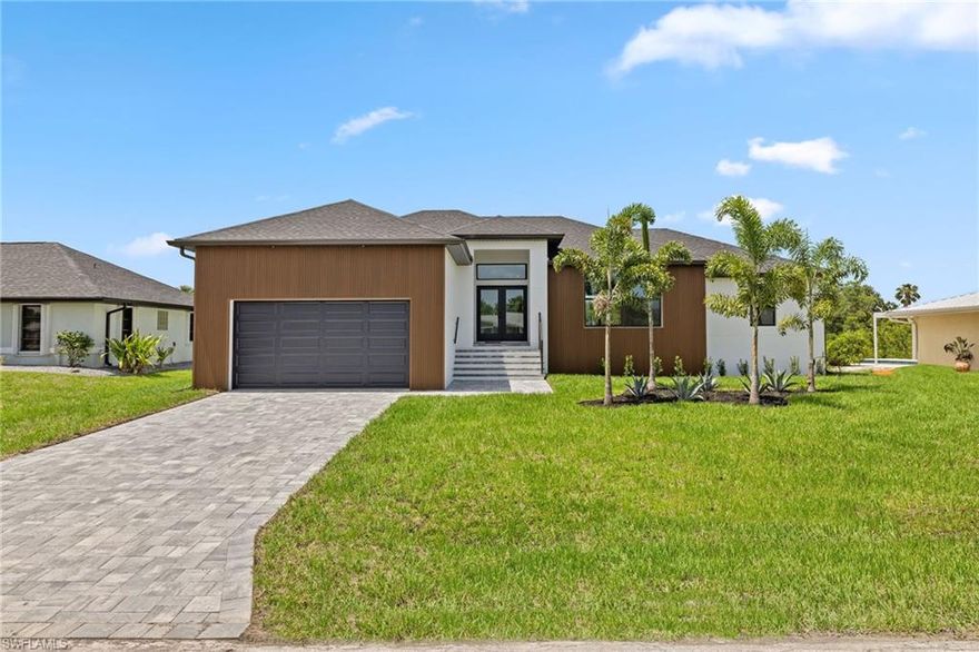 One or more photo(s) has been virtually staged. This brand-new contemporary 3-bedroom, 2-bath waterfront home is the perfect forever home -designed with thoughtful details, quality craftsmanship, and an unbeatable location. Built by Quality Home Builders, this turnkey residence comes complete with all-new appliances and carefully chosen finishes. Inside, you’ll love the open floor plan with 10 ft high tray ceilings, recessed lighting, and porcelain plank tile. The kitchen includes a large pantry, while the 2-car garage and ample storage bring everyday convenience. Peace of mind comes built in with hurricane-impact windows and doors, an 11.5 ft elevation, and an elevated A/C unit, so flooding is never a concern. Step outside to enjoy 80 feet of private waterfront living. Relax on the covered back patio or take advantage of the brand-new composite dock and 12,000 lb Golden boat lift. With no bridges, you’ll have direct sailboat access and be in open water in under 15 minutes. The lot also offers plenty of room for a pool, giving you endless ways to enjoy Florida’s outdoor lifestyle. Located in a quiet canal community near the Myakka River, Port Charlotte Beach Park, Charlotte Harbor, and Fisherman’s Village, this home gives you easy access to beaches, boating, shopping, and dining - all with no HOA fees.