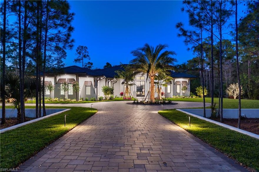 Just completed custom estate set on an expansive approx. 0.69-acre homesite within the gated enclave of Naples Club Estates, directly adjacent to Naples National Golf Course. Preserved views and exceptional privacy offer estate-level scale rarely found this close to Naples’ beaches and downtown. The thoughtfully designed single-story residence offers  nearly 9,700 sq ft of total living space, featuring 5 bedrooms arranged in a well-defined layout that balances openness with privacy. Interiors are finished with wide-plank Legno Bastone European French Oak flooring, soaring ceilings with custom beam detailing, refined millwork, and a cohesive designer palette throughout. Living spaces are thoughtfully delineated rather than fully open, creating a sense of architectural structure while maintaining seamless flow to the outdoor areas. The designer kitchen is a standout, featuring custom wood cabinetry with reeded detailing, glass-front display uppers, and integrated lighting. A waterfall Perla Venata quartzite island and matching countertops,, anchor the space and pair beautifully with a walk-through pantry for optimal function. The professional appliance suite includes Sub-Zero refrigeration and wine storage, Wolf induction cooking and wall ovens.. A built-in wet bar with stone surfaces, beverage refrigeration, and wine storage enhances entertaining while maintaining a tailored, architectural aesthetic.The primary suite is a serene retreat with tranquil preserve views and direct lanai access. Architectural wall detailing, layered lighting, and generous proportions create a calm, refined atmosphere. The spa-inspired primary bath features a freestanding soaking tub, oversized glass-enclosed shower with dual rain heads and hand shower, large-format stone and porcelain tile, custom dual vanities with stone countertops, & custom closets. Additional en-suite bedrooms are generously sized, each offering private baths finished with custom cabinetry, stone surfaces, & curated tile selections. providing comfort and privacy for family and guests. Outdoor living is a true resort-style experience, with a large screen-enclosed pool and spa featuring illuminated water elements and a dramatic linear fire feature. The covered lanai includes a fireplace, fully equipped outdoor kitchen, dedicated bar area, pool bath, and outdoor shower, with multiple lounge zones for dining, entertaining, and relaxation surrounded by tranquil preserve. Built by Forge Construction to increadible standards, the home includes impact-rated windows and doors, smart-home integration, dual-zone HVAC with dehumidification, tankless gas water heaters, a whole-house generator, and premium materials throughout. Naples Club Estates is prized for gated privacy, estate-sized homesites, and preserved natural surroundings, offering a rare blend of exclusivity and convenience in one of Naples’ most discreet luxury communities.