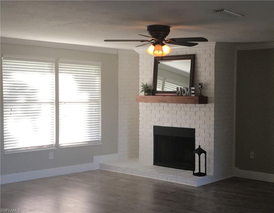 LOOK NO FURTHER – GREAT OPPORTUNITY TO GET INTO THIS UPDATED SINGLE FAMILY WATER FRONT HOME. This Beautiful 2 bedroom, 2 bath home features an open floor plan with a fireplace and a brand new high end custom kitchen w/stainless steel appliances. The kitchen has gorgeous granite countertops with all real hardwood cabinets and dove-tail drawers. The kitchen cabinet doors and drawers are all self-closing – even the trash pull-out! The bathrooms have been wonderfully updated with newer vanities and lighting. The brand new dimensional shingle roof and new exterior paint gives a warm and welcoming appearance to the home. There is new flooring throughout for easy maintenance and goes beautifully with the 5.5” baseboards.  The color pallet, open floor plan and sliding barn door really gives this lovely home a nice modern twist.  It wouldn’t be a Florida home without the fruit trees and the beautiful canal view from the backyard. This home is conveniently located close to shopping, dining, beaches and airport. There are really just too many features to list here.  What are you waiting for?  You must come see this for yourself.  Schedule your appointment today!