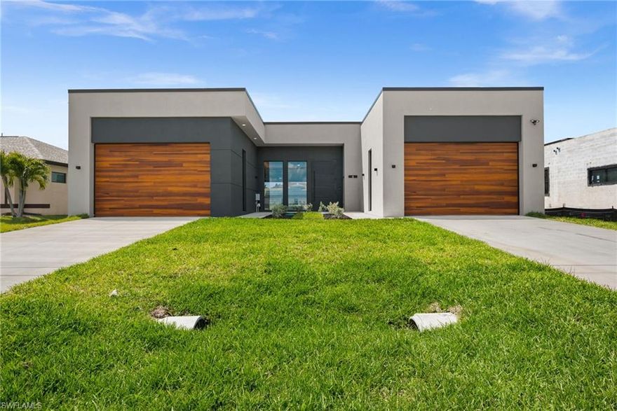 WESTERN exposure canal-view home offering breathtaking sunset views and a modern design that stands apart.

This 4-bedroom, 3-bath home features clean contemporary architecture paired with high-end finishes and a thoughtfully designed layout that goes beyond typical new construction.

Inside, 13-foot ceilings and dramatic 10-foot impact windows create a bright, open living space filled with natural light. A striking 10-foot steel front entry door sets the tone, while oversized interior doors and expansive hurricane impact sliding glass doors allow for seamless indoor-outdoor living.

The main living area opens to a spacious lanai with an infinity-edge pool and spa, perfectly positioned to take advantage of Florida Sunsets. A panoramic picture-window screen enclosure maximizes canal views without visual obstruction.

The kitchen offers quartzite countertops, custom cabinetry, and high end fixtures, complemented by spa-inspired bathrooms and custom closet systems throughout.

A standout feature of the home is the dual 2-car garages located on opposite sides of the property, providing flexibility for storage, recreational space, or additional lifestyle use.

This property combines modern design, quality construction, and a prime waterfront setting to deliver a refined and distinctive waterfront living experience.