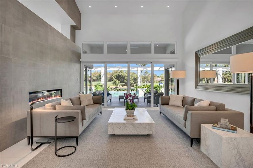 Welcome to this spectacular, contemporary residence, set on a sprawling estate lot, with expansive lake views and the 5th fairway of the newly-opened Pines Course in the distance. Completely redesigned in 2017 in every aspect, this home offers the epitome of luxury living with its unparalleled design and unrivaled attention to detail.  This home features a seamless blend of modern elegance, coastal chicness, comfort and warmth. The gourmet kitchen is perfect for entertaining and boasts of two islands and beautiful, abundant wood cabinetry. Another unique feature of this home is the outdoor living space, with summer kitchen, dining and lounge areas, and the fabulous resort pool, completed in 2021. The seamless flow from indoor to outdoor living spaces allows for effortless entertaining and relaxation. Your guests will enjoy their privacy upstairs, with two bedroom suites, kitchen and living area, and hardwood floors throughout. You will love the ease of parking in this 4-bay, drive-through garage, with lift in the single garage. Beautiful landscape design by Christian Andrea, mature trees, guest parking, and situated on a sought-after street, close to Club amenities. Welcome home!