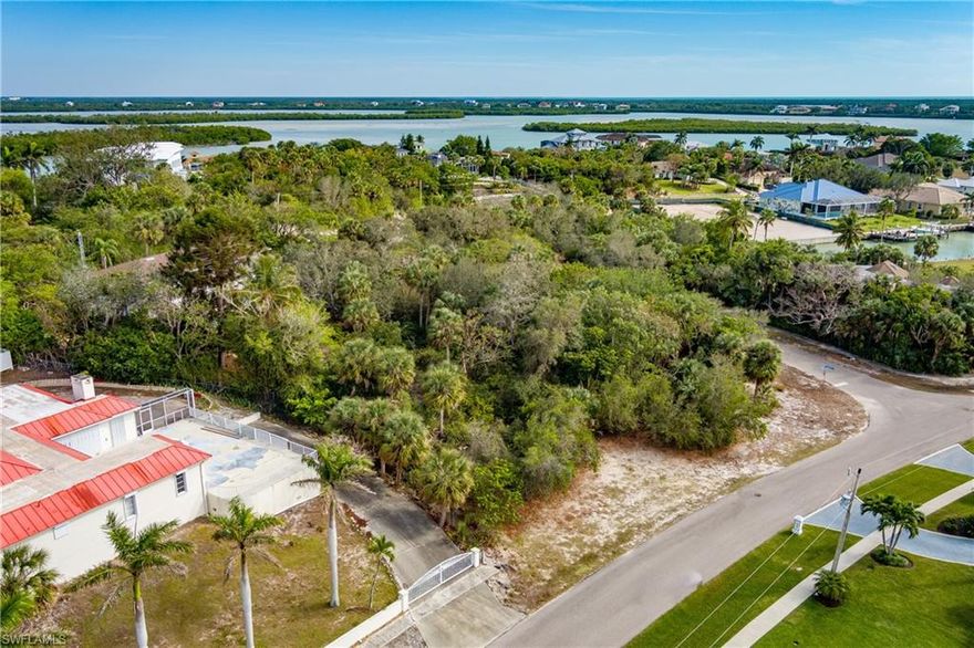 Nestled in the exclusive Estates area of Marco Island, this extraordinary .57-acre, oversized corner lot offers a rare opportunity to craft your very own paradise. Positioned at the base of Indian Hill, this unique location has the potential for beautiful views that will make your daily sunrise and sunset moments unforgettable. The building envelope is in the X flood zone and slopes upward in elevation towards Indian Hill. Imagine the endless possibilities as you design your custom dream home, with ample space to create a perfect blend of luxury, comfort, and harmony with the surrounding natural beauty. Surrounded by stunning multi-million-dollar homes, this property provides the perfect backdrop for a tranquil and private lifestyle. It’s more than just a homesite—it’s a place where memories are made and cherished for generations to come. For those seeking greater insight into the land, a Boundary Survey, Cultural Resource Assessment (Archaeological Assessment) and a 2020 Gopher Tortoise Survey Report are available, offering valuable details about this remarkable property. Don’t miss out on this incredible opportunity! Discover the beauty of the Estates, uncover the incredible potential of this remarkable lot, and begin bringing your dream home to life today