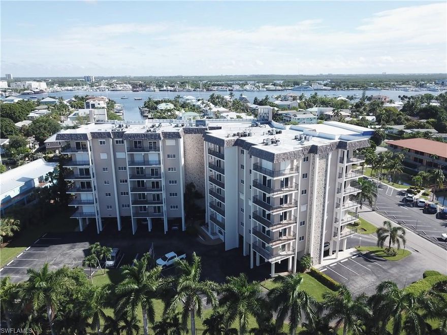 Batiki West is located in the heart of Ft. Myers Beach, right across the street from the Gulf of Mexico and a short walk to the Margaritaville Resort (completion date 2023).  This exquisitely remodeled unit boasts many upgrades, including a completely renovated kitchen with hickory wood cabinets, double-drawer dishwasher, and extra refrigerator.  Both bathrooms are beautifully updated and appointed with dual showerheads and glass block in the Master bath and stunning tile work in the Guest bath.  All of the windows and the sliders are high impact. This unit is one of the few in the building with a laundry room; both the washer and dryer are Bosch.  The A/C is new (April 2021).  A highly coveted under-building parking space is included with this property.  Batiki West is also located on a Back Bay-access canal where you can lease your own dock space for those boating days. This outstanding residence is the perfect place for anyone seeking the ultimate beach and waterfront lifestyle of Ft. Myers Beach.