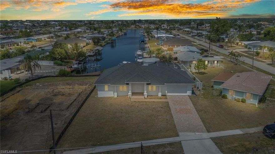 OVERSIZED LOT **Waterfront Paradise – Turn-Key & Furnished!**Located in the heart of Port Charlotte. This *almost brand-new* 3-bedroom + flex room, 3 bathroom, POOL home, sits at the end of a quiet canal, offering stunning water views and direct access to the open water. Plenty of entertaining space and a hot tub to unwind. Enjoy your private dock and boat lift—perfect for boaters and sunset lovers alike! Have piece of mind under your solid new roof, 2023 Air Conditioner, and a home that sits high & dry :) Step inside to a bright, open floor plan with stylish finishes throughout. The flex room offers the perfect space for a home office, guest room, or hobby area. Includes a large laundry and pantry. Fully furnished and truly *turn-key*—just bring your toothbrush and start living the dream!