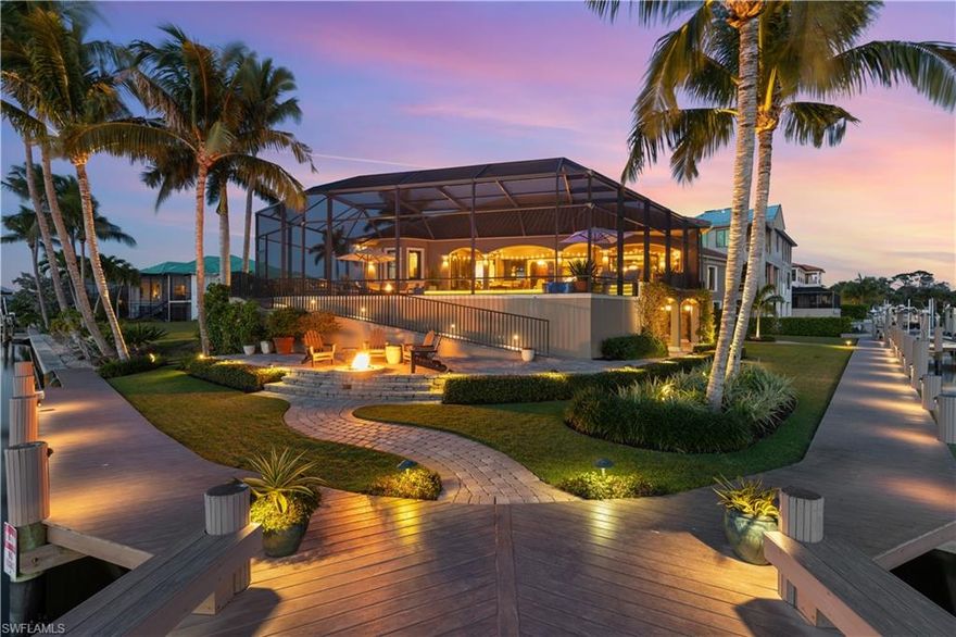 Welcome to Bayside beauty where everyday welcomes you with panoramic water views.  This luxurious custom built Cotter home was perfectly situated in the culdesace of this southwest facing lot with entertaining in mind.  As you walk through the arched mahogany front door you are greeted with an expansive yet cozy Open floor plan with high ceilings and an expansive multi-level outdoor space that takes in all the Bay has to offer. You will enjoy cooking in this beautifully appointed kitchen with it's unique island bar that allows the cook to easily engage with their guest. Everyone feels included and seen from inside the home to out. And speaking of outside, enjoy the beauty of the pool and spa during the day and the fire pits by night; One on the lanai and one located along the 200 foot boardwalk around the home that is great for enjoying those amazing SWFL sunsets. This home also includes it's on boat dock which includes water, electric and 10,000 lb lift allowing easy access to the Gulf of Mexico. This home is conveniently located just one mile from white sandy beaches of SWFL. The Ritz Carlton, Mercato and Waterside shops are also near by offering many dining and shopping options.