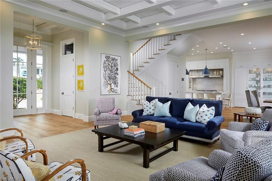 A true Old Florida Style Home built to the top of Naples standards sits perfectly nestled in a quiet enclave west of Crayton Rd. Thoughtfully designed to take advantage of the oversized lot, the open and airy floor plan has a sprawling first level along with a circle drive to easily accommodate residents and guests and dedicated driveway to access the 3-car garages. The interior has a sophisticated, southern charm with bleached oak floors, custom shiplap walls and pops of color through exquisite wall coverings. Enter in through the rich mahogany front door and be greeted by custom floor to ceiling sliders which lead directly to the relaxing outdoor living space complete with fireplace, summer kitchen and outdoor shower. The kitchen is a dream with leather finished white quartzite countertops, custom cabinets and fixtures that complete the look. True beauty is in the details and this is easily imagined in this one of a kind, coastal retreat. Residents will appreciate the private beach of the Moorings just a few minutes away.