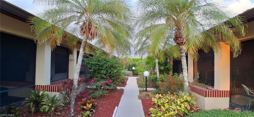 Discover incredible value in this beautifully maintained 2-bedroom, 2-bathroom end-unit villa, just minutes from 5th Ave and the stunning Naples beaches. Enjoy the ease of first-floor living with no neighbors above, complemented by hard surface flooring throughout, newer appliances, and solid oak cabinetry. The cathedral ceiling adds an airy, open feel, while impact windows and extra bedroom & master bath windows provide refreshing cross-ventilation.  Step outside to the rear lanai, which can be enclosed as a sunroom or expanded living space, and take advantage of the option to add a 10-foot private patio with lush landscaping for extra seclusion. This low-density community offers a pool, spa, and sauna, all included in the affordable maintenance fees covering cable. Plus, a carport and storage unit add extra convenience. Furnishings are negotiable—move right in and start enjoying the Naples lifestyle!