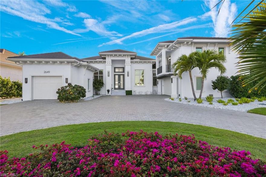 Welcome to 2649 Tarpon Road in prime Royal Harbor location boasting 100 feet of stunning Naples Bay frontage.  Built in 2019 by Big Island Builders this incredibly designed western facing custom home features 5 Bedrooms and 6 Baths in almost 5300 square feet of living space under A/C.  Enter the dramatic foyer to courtyard views of the outdoor saltwater pool, spa, fountain and bay views.  Dramatic ceiling heights throughout and handsome wide plank hardwood floors.  Impeccable craftsmanship and attention to detail throughout.  Lovely office with custom built-ins.  Open-concept living area with walls of sliding seamlessly blending indoor/outdoor living.  
A true chef's Eat-in Kitchen replete with Sub-Zero and Wolf appliances.  Spacious Living Room with custom built-ins designed by Clive Daniel.  Step out to your outdoor dream living space ideal for entertaining outdoor built-in kitchen plus separate living area with linear gas fireplace and custom mantle.  Dock accommodates a 36' boat plus jet ski lift.
Master suite oasis complete with large Bedroom opening out to pool area, 2 oversized walk-in closets with custom built-ins and a spa-like bathroom with oversized marble walk-in shower, separate vanities, water closet and soaking tub.  A second guest suite, large laundry room, storage room and pool half bathroom complete this living floor.  Upstairs are 2 separate quarters ideal for guests, live-in staff, in-law quarters, office, gym or studio.  Easy access to downtown and beaches.  Truly an exceptional home and setting.