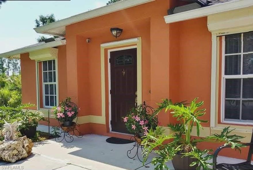 Beautiful, very well maintained house in the heart of the Lehigh Acres with enchained, unique garden created by professionals!
NEW roof in 2020, ide gutters
Hurricane shutters (mechanical and accordion type) 
recently upgraded AC
NEW water heater
NEW water system Reverse osmosis 
security cameras around the house
irrigation sprinkler system
low voltage landscape lights
fence
Few new windows
concrete around base of the house
concrete resting areas on the back with shading tree
NEW walk-in shower in a guest bathroom 
NEW kitchen  
Professional DESIGN of garden with some fruit trees. 
It is located close to Walmart, Bravo, Aldi, different shopping centers and restaurants.
it is a must to see!