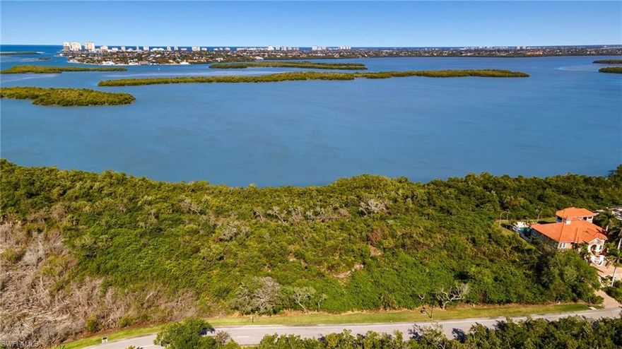 Seize the extraordinary opportunity to craft your dream home on this expansive homesite, spanning over half an acre in the prestigious, gated Key Marco community. This oversized lot offers an exquisite blend of privacy and natural beauty, surrounded by vibrant preserves and the captivating Blue Hill Bay. Build up to enjoy breathtaking wide-water views and direct access to the Gulf. Boat dock and lift comes with lot. Key Marco embodies a lifestyle of luxury and leisure. Residents are treated to exceptional amenities, including a secure gated entrance, a community clubhouse with a fitness center, versatile indoor and outdoor gathering spaces, tennis and pickleball courts, a dog park, and a private marina with a deeded boat slip accommodating vessels up to 40 feet. Ideally located at Marco Island's southern tip, this property provides swift access to the Gulf of Mexico for boating, fishing, and sightseeing, free from bridge restrictions and boat height limitations. Explore miles of scenic trails perfect for biking and jogging, or relax at the private marina and fishing piers. With Key Marco's rich history and natural splendor, the community is home to diverse wildlife, such as the enchanting Roseate Spoonbill. Spanning 546 acres, with 375 acres dedicated to natural habitat, Key Marco offers only 134 homesites amid rolling terrain, rising to 45 feet above sea level, with new homes priced in the $8+ million range. Conveniently located near grocery stores, shops, restaurants, and stunning beaches, Key Marco stands as one of Florida's most exclusive, serene communities. Don't miss the chance to create your paradise in this exceptional setting—this remarkable property truly must be experienced to be fully appreciated!