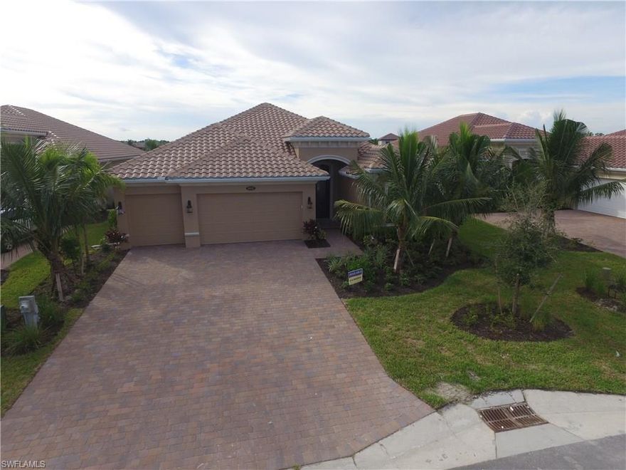 This under construction Hawthorne plan is situated on a lakefront home site and features wide water views. The spacious Great Room concept with volume ceilings and fully pocketing triple sliding doors completely opens your beautiful new home to a lovely pool and spa with picture frame screening.  Standard features include impact resistant windows and doors, a tankless hot water heater, tray ceilings with coffers and crown molding in living areas and master suite.  The kitchen includes 42” level 5 painted maple stone light gray cabinets with Cambria summerhill quartz, gas cooktop with stainless steel vent and French door refrigerator.   Additional features include a three-car garage, solid core eight-foot doors and baths featuring white cabinets and granites .  Tile on the brick pattern is featured in the living areas with wood flooring in the master suite and den.  This home also includes a gas spa heater and pool auto-fill/overfill system, salt chlorinator system plus a fully equipped outdoor kitchen and pool bath!  Fiddler’s Creek is an award winning resort community featuring a 54,000 sq. ft. Club !!