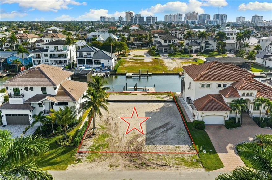 Welcome to 418 Seagull Ave — a cleared, build-ready waterfront homesite in the heart of Naples’ highly coveted Vanderbilt Beach/Conners community. This quiet short cul-de-sac street is lined with impressive new construction, offering a peaceful setting surrounded by luxury homes all directly on the water as well.

The lot is approximately 75' wide with highly desirable southern rear exposure, providing warm natural light across your future pool, outdoor living area, and waterfront views from sunrise to sunset. A newer dock already sits behind the property, allowing immediate enjoyment of the water or easy integration into your new design. Water and sewer connections are already in place, and you will benefit from lower impact fee's for rebuilding on a site where a previous home existed, helping streamline the construction process and save you money on the build.

Here, it is fully feasible to design and build well over 6,000 square feet of luxury living space if you would like with height allowances of up to 35 feet, making a rooftop deck or elevated outdoor living level an incredible option for long views and magical Naples sunsets amongst the treetops. With NO HOA, the neighborhood allows many architectural styles, so build your dream house on this well-suited to the lot. We have luxury builders and architects standing by—or bring your own builder and architect to bring your ideal waterfront home to life.

Location is the true highlight. You're minutes from The Ritz-Carlton Beach Resort, La Playa Beach & Golf Resort, and the iconic Turtle Club Restaurant, making this one of Naples’ most walkable, beach-accessible boating communities. World-class shopping and dining await at Mercato, Waterside Shops, and 5th Avenue South—all a short drive away. Traveling is effortless with Southwest Florida International Airport (RSW) just 30 minutes north.

On a street filled with luxury homes—including a residence listed for over $12M.  418 Seagull Ave stands as one of the best opportunities in Conners. Waterfront lots under $2M with premium southern exposure on a quiet cul-de-sac simply do not come around often. 

Design your dream waterfront retreat and enjoy one of Naples’ most desirable central locations—where boating, beaches, dining, and luxury living all meet.