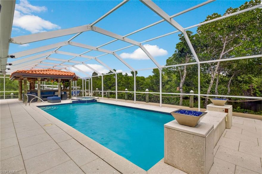 Welcome to your private TROPICAL PARADISE! This beautifully renovated single-family home offers the ultimate waterfront lifestyle with direct access to the Caloosahatchee River. The heart of the home is an expansive, sun-filled family room designed for effortless entertaining, which flows seamlessly out to a spectacular pool area.
Step outside to find your own backyard oasis, featuring a massive resort style chickee hut and bar that brings those authentic island vibes right to your doorstep. Whether you are launching your boat for a sunset cruise or hosting friends and family poolside, this home perfectly captures the essence of luxury living on the water. Don't wait too long to experience the true meaning of Florida living—this opportunity doesn't come around very often!