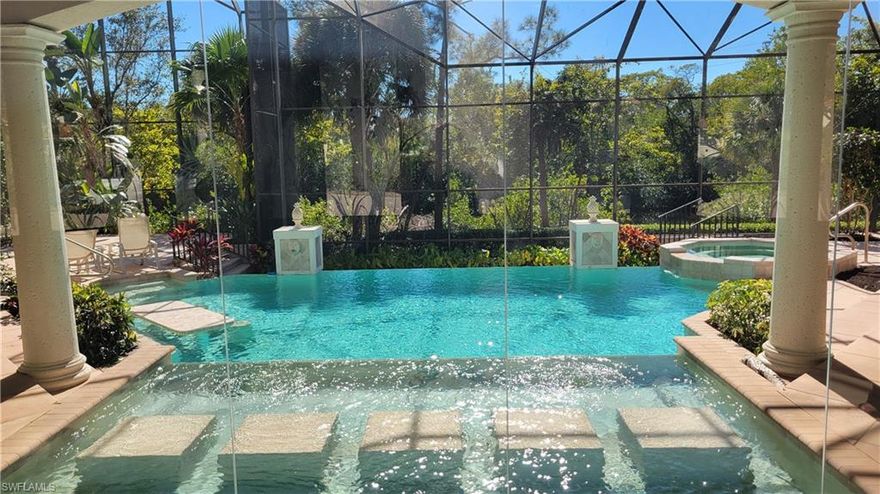 THE LARGEST OF ONLY 5 RIVERFRONT HOMES IN COLLIER'S RESERVE.Southern Orientation located at end of Private Cul-De-Sac.  Available for immediate Golf Membership, by-pass waitlist. 
This elegant and inviting home seamlessly integrates indoor and outdoor living and entertainment. From the moment you enter the double front doors you will be drawn to the view by a wall of glass, overlooking the double infinity edge pool, fountain and hot-tub. The home features 4 Ensuite Bedrooms, Study and Powder Bath, Full Pool Bath and an Oversized 4 car garage.
The open concept Living Room and Kitchen has no obstructions with zero corner pocketing sliders accessing the spacious lanai with covered dining, multiple sun decks,  summer kitchen bar and grill, Pool Bath and lush tropical landscaping.  The large intricate pool includes an upper spillover fountain with lily pad steps to get across the water, the main pool with adequate room to do laps or sit on the bench with in pool table, or enjoy the hot tub, pool and hot tub are heated by propane gas and electric heat pump.  Just steps down the deck is the dock with access to the gulf via flats boat, kayak or paddle board. 
The master suite has a full view of the lanai and also privacy set off from the main lanai activities.  
Within the master suite is a morning kitchen, his and her closets with organizing systems.  The spa like bath includes a jetted tub, walk in shower with multiple shower heads, dual sinks and vanity dressing area. 
Two ensuite guest bedrooms are on the first floor, one with a private screened patio to enjoy morning coffee, the other situated away from the activity of the home.  A large private suite located upstairs with a morning bar, overlooks the entire lanai and river view via a balcony.
The oversized 4 car garage can house all your vehicles and toys including a golf cart and full size suv.  
Quality details have made this home timeless including large format stone flooring, real wood flooring, ceiling accents and recesses, extensive accent and cabinetry lighting, landscape lighting, integrated sound system, 8' solid core doors throughout, security system and much more. 
This home having been loved for 25 years by the original owners has all of the elements for a new family to make their own, with cosmetic updating to meet current lifestyles. New Roof.
Within Walking Distance to the Colliers Reserve Golf and Country Club and BoatHouse Dining.  All residents must join CRCC.  Purchaser of this home eligible for immediate Golf Membership, bypassing the waitlist.  For current fees and information,  please inquire.