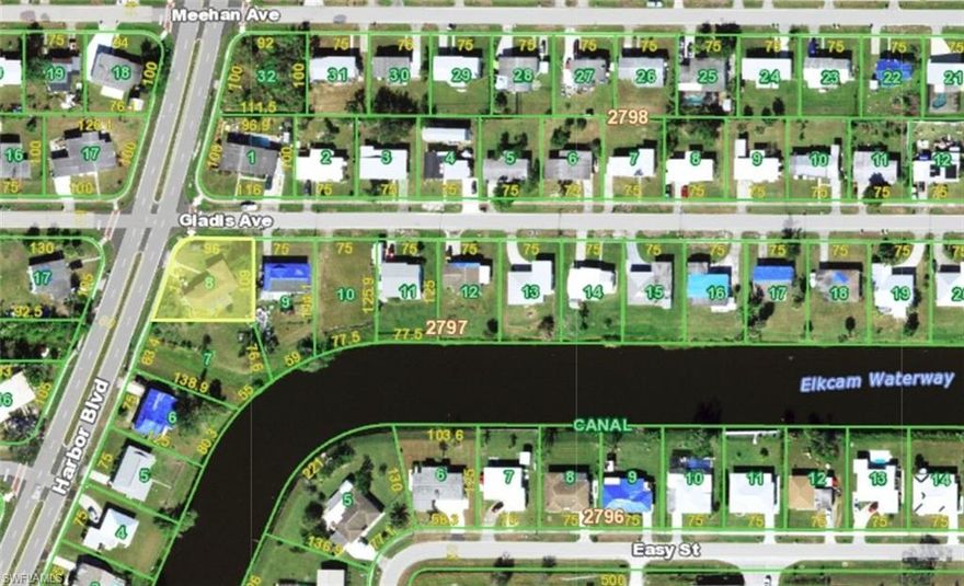 INVESTOR ALERT.  With a little TLC you can turn this NEARLY 1,600 Sq Ft, 3 BEDROOM, 1.5 BATH, 1 CAR GARAGE HOME on a CORNER LOT into your dream home. This home has lots of flex space is available to move in immediately. Upon entering, you’ll notice the living room with the spacious kitchen and dining areas to the right and bedrooms to the left, providing the privacy of a split plan. The functional kitchen and adjoining dining area offer tons of built-in storage. Beyond the living room, find access to the primary bedroom, full bath, guest bedroom, and a half bath and a huge hallway storage closet. A GREAT ROOM runs across the back of the home providing beautiful views of the Elkham Waterway canal, which leads to Charlotte Harbor. Adjoining the Great Room is the third bedroom with its own PRIVATE ENTRANCE (potential rental income?). This home is surrounded by mature landscaping, including bearing fruit trees. Located in the heart of Port Charlotte you are within walking distance of the hospital and you will enjoy convenient access to I-75, US-41/Tamiami Trail, shopping, schools, hospitals and an array of outdoor recreational activities. Nearby airports include Punta Gorda, Ft. Myers, Sarasota, St. Pete and Tampa. Home being sold as is. Call today to schedule your private showing.