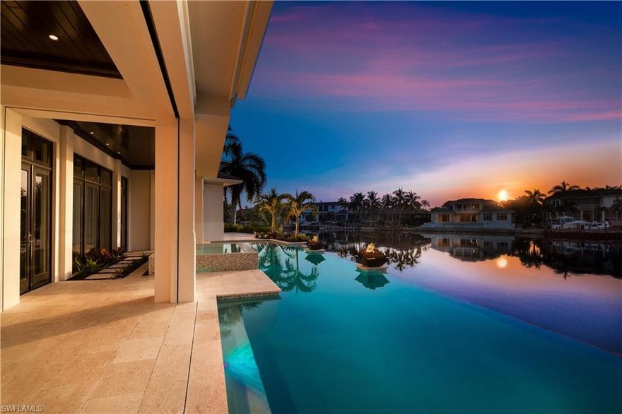 This stunning newly constructed two-story concrete block home is situated on a prime waterfront lot offering panoramic water views. Classic transitional interior design with superior quality, this open floor plan with walls of glass dazzle the eye. The elegant first-floor master suite and guest en-suite transition to the alluring outdoor expansive covered areas and the large 50+ foot zero infinity-edged pool and spa.  Three additional en-suite guest rooms on the 2nd level surround the large gathering room and covered balcony framing the amazing bay views. Fully equipped with the Control4 home automation system, gorgeous Ruffino Cabinetry, Legno Bastone wide plank hardwood floors, Wolf®, Sub-Zero® and Miele® appliance package, convenient catering kitchen, temperature controlled wine showcase and extensive detailed millwork throughout. This beautiful waterfront smart home is moments away from world-class upscale shopping and dining at Waterside Shops and Venetian Village and the sugary sand beaches at the private Park Shore Beach access.