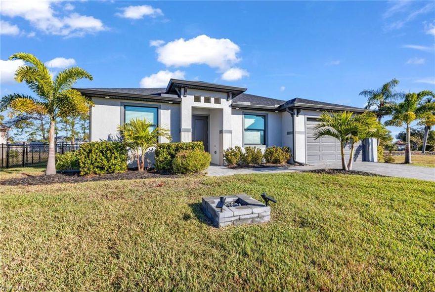 Built in 2023, this nearly new 4 bedroom, 2 bath home offers 1,800 sq. ft. of high-end Florida living with soaring 14-foot ceilings throughout and elegant tray ceilings in the main living areas and primary suite. Designed with luxury and peace of mind in mind, the home features granite countertops, tile flooring, and hurricane impact windows. The two-car garage with epoxy flooring adds both style and function. Step outside to an oversized fenced in yard and spacious screened lanai, perfect for entertaining or unwinding. Even better, no one can build next to you, as the home sits adjacent to the community park, offering privacy and open views. The Burnt Store Village Community offers walking and bike paths, lakes, playground, and gazebo, all with a low HOA of just $220 yearly. Just across the street from Burnt Store Marina, giving you quick access to boating and the best of Florida waterfront living.