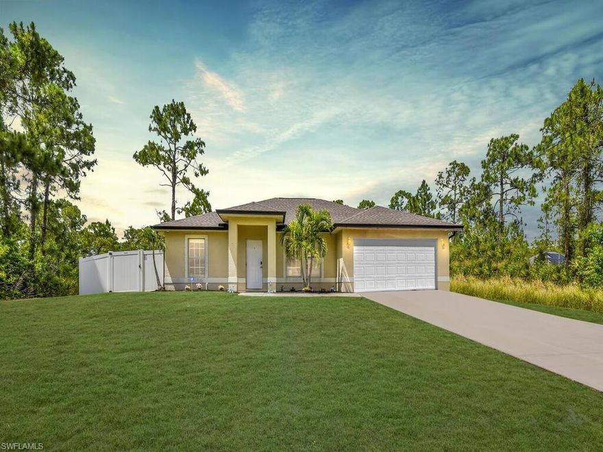 Unique opportunity - DOUBLE LOT w/ single family home! This property has plenty of room for all of your toys and/or to add a pool or add a detached workshop/garage. The backyard is entirely enclosed w/ a tall privacy fence that has a double door entryway from the rear of the parcel. Inside the single family home you will find a comfortable layout, great room design, open concept kitchen, split bedroom floor plan, tile flooring throughout, cathedral ceiling, split bedroom floor plan, in-residence laundry room, rear lanai, security cameras included and an attached 2-car garage.  In the backyard is a custom built chicken coop. Fantastic location- situated in a highly desired non-gated area in Lehigh Acres. Close to lots of shopping/dining options, short drive to public golf courses and boat ramps, plus near community parks & libraries. *Garage has a Mini-Split working air conditioner*