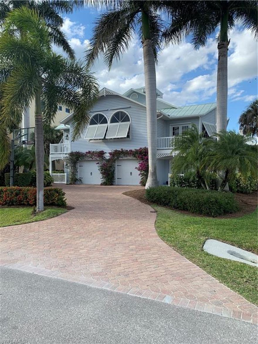 This is a beautiful Key West style home in the wonderful boating neighborhood of Conners, Vanderbilt beach. Take your boat from the backyard right out to the Gulf of Mexico! Or take a short walk/bike to Vanderbilt beach. The upstairs boasts 3 bedrooms and 2 full baths with a large family room and dining area. The downstairs is nicely built out and has a large game room and an extra large bedroom with plenty of beds to sleep friends and family. The house also has a private elevator. The lower level also has a full bathroom and easy access to the pool and spa deck. Once on the back pool deck you will see the oversized boat dock. The boat dock was recently redone and was extended up to the screened in pool deck. The oversized boat dock is an amazing area to hang out, store paddle boards, get some sun, or just prepare the boat for a great day on the water. Professional Photos coming soon!