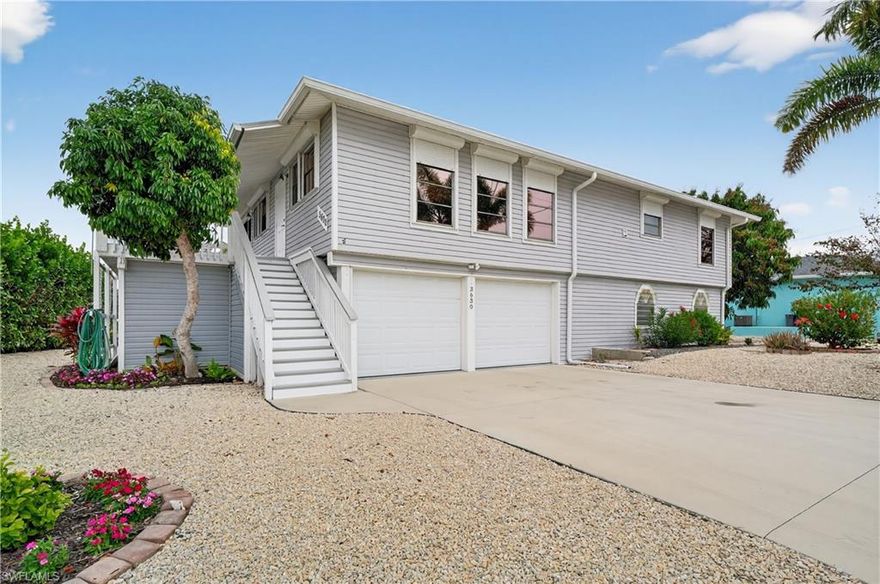 "SALT-LIFE" BOATING-FISHING-BEACHES-ISLANDS! STUNNING "OLD FLORIDA" stilt home, with $1,000,000 VIEWS! Private Boat Dock with Canopy/Cover, Boat lift, Sea wall and Composite Dock.  REMODELED ($100,000+/-) 2 BEDROOM, Open DEN, 2 full BATH, 2 CAR GARAGE with extra storage, elevated and as safe as possible from future sea surge. ELECTRIC "ROLL DOWN" STEEL SHUTTERS ON ALL WINDOWS. Boaters Dream Home! Huge OPEN FLOOR PLAN, ALL TILE FLOORS IN LIVING ROOM, KITCHEN AND BATHROOMS. "Wood Plank" Vinyl tile flooring in the bedrooms for easy maintenance. "CHEFS KITCHEN" LOTS OF CABINET AND COUNTER-TOP STORAGE AND SPACE, GRANITE TOPS LONG EAT-AT-BAR AND WALK-IN PANTRY. Huge screened LANAI, over looking the open channel. Master bedroom has completely remodeled bathroom with Granite vanities and walk-in glass & tile shower. Minutes to the open waters of the Gulf of Mexico on a large deep canal, featuring an 8,000lb boat lift with remote & cover, two davits and 40 linear feet of seawall to park your BOAT. Convenient location IN & OUT OF SAINT JAMES CITY AND THE ISLAND! This COMMUNITY is a golf cart community & just minutes to all the local restaurants, waterfront bars, 17 miles of bike paths, and much more. Open concept floor plan features a huge master suite with a remodeled en-suite master bath and an enormous walk-in closet and a bonus room! Make this your home office, workout room, or craft area. Screened lanai with a built-in commercial stainless steel exhaust hood fan for all of your BBQ gatherings. DOWNSTAIRS, IS A LARGE VERSATILE AREA HAS ADDITIONAL space for DEN, WORKSHOP OR STORAGE and you can park up to 6 vehicles! Lots of fruit producing trees, 3-rack kayak storage, water and electric at the dock, fish cleaning station and gardening station. Storm protected and energy-conscious, this home includes a generator hook up with bypass switch, plus sprayed-in attic insulation. HOME COMES WITH ONE-YEAR "HOME WARRANTY"  FOR TOTAL BUYER COMFORT! BUYING ON THE ISLANDS, LOOK FIRST TO ELEVATED HOMES!