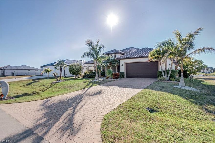 Welcome to your private slice of Southwest Florida paradise, where breathtaking canal views, elegant design, and exceptional value come together in perfect harmony. This stunning Gulf-access waterfront home offers the lifestyle buyers dream about—serene water views, beautiful sunsets, and effortless indoor-outdoor living. From the moment you arrive, the home’s impressive curb appeal, paver driveway, and lush tropical landscaping set the tone for what awaits inside. Step through the grand entry and you’ll immediately notice soaring ceilings, expansive open living spaces, and walls of glass that frame picturesque canal views and fill the home with natural light, creating a bright and inviting atmosphere.

The spacious great room flows seamlessly into a beautifully appointed chef’s kitchen featuring rich wood cabinetry, granite countertops, stainless steel appliances, and a large center island that serves as the perfect gathering space for entertaining. Whether hosting family and friends or enjoying quiet evenings at home, the open floor plan offers both comfort and functionality. The primary suite provides a peaceful retreat with generous space and calming water views, while additional bedrooms offer flexibility for guests, a home office, or hobbies.

Step outside to your private waterfront oasis and experience true Florida living. This incredible property offers expansive canal views, a private dock, and covered boat lift, making it ideal for boating enthusiasts or anyone who appreciates the beauty and tranquility of waterfront living. Imagine starting your mornings with coffee overlooking the water, spending afternoons boating, and ending your evenings watching stunning sunsets from your own backyard. Additional highlights include tile flooring throughout the main living areas, elegant architectural details, a spacious laundry room, abundant storage, and a large walk-in pantry.

Virtually staged to help you visualize the possibilities, this home showcases its full potential as a sophisticated waterfront retreat where every space invites relaxation and enjoyment. For this price, it is truly an exceptional value, offering the rare opportunity to own a beautiful Gulf-access canal home with space, quality, and breathtaking views. Whether you’re searching for a full-time residence, seasonal escape, or investment opportunity, this home delivers the ultimate Florida waterfront lifestyle. Schedule your private showing today and experience canal living at its finest.