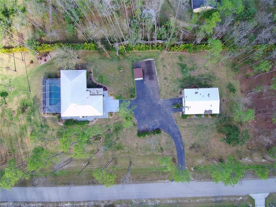 QUIET PIECE OF PARADISE!! Beautifully manicured 2.81 acres of cleared land surrounded by woods, offering a true private ranch feel! New Metal Roof. This concrete block built home features 3 bedrooms and 2 full baths. Open floorplan provides a cozy, quaint feel. Split bedrooms with tile throughout the entire home. Upgrades include new custom lighting fixtures and ceiling fans throughout the home, Stainless Steel appliances, granite countertops, gorgeous backsplash, new washer and dryer. Renovated Master Bathroom. 2 car garage. Relax poolside in your large screened lanai overlooking serene acreage with your entire property high and dry with fresh sod grass and beautiful fruit trees. 30x40 Workshop with front and rear entrances built in 2014 is insulated and includes generator. Ideal as a large workshop. Perfect for storing your collector cars. Plenty of room for your RV. Equestrian lovers can convert workshop into a stable and property becomes a horse lovers paradise! Endless opportunities in this LIFESTYLE PROPERTY!