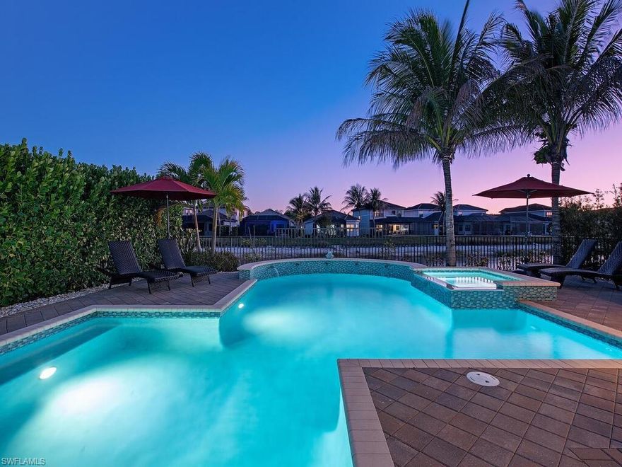 Offering more than 4,100 square feet of refined living, this six-bedroom, six-bath lakefront residence in Stonecreek presents a rare opportunity to live expansively while embracing the effortless elegance of the Naples lifestyle. From the moment you enter, polished marble flooring spans the entire first floor, creating a seamless, luminous foundation that carries you from the welcoming foyer to the sparkling pool and lake views beyond. Designed for both elevated entertaining and relaxed everyday living, the main level unfolds with a formal living room anchored by a striking fireplace feature wall, an elegant dining room, and an inviting family room that flows seamlessly into the kitchen. The gourmet kitchen is as beautiful as it is functional, showcasing glazed cream cabinetry with a contrasting island, GE Café appliances including a double oven and vented hood, granite countertops, ambient lighting, and a walk-in pantry with extended under-stair storage. A first-floor guest suite with adjacent full bath, a convenient mudroom, and a unique, dedicated cabana bath ensure comfort and convenience for both residents and guests—especially after a day poolside. Upstairs, five additional bedrooms and four full baths provide exceptional flexibility. The spacious loft creates the perfect setting for movie nights or a secondary lounge. The primary suite serves as a private retreat, complete with its own balcony overlooking the lake—ideal for sunrise coffee or evening unwinding. Dual walk-in closets and a spa-inspired bath with separate his & her spaces connected by a frameless glass shower complete the sanctuary experience. Refined details elevate the home throughout: plantation shutters, designer drapery, motorized shades, decorator lighting & fans, crown molding, hardwood flooring on the stairs and upper level, an upgraded wood and iron stair rail, tankless water heater, finished laundry room, and hurricane-impact glass for effortless storm preparation. Outdoors, the fully fenced yard is framed by lush tropical landscaping, creating a private resort ambiance. The oversized custom gas-heated saltwater pool and spa—accented by waterfall sconces—invite long afternoons in the sun and evenings under the stars. Stonecreek residents enjoy a true vacation-inspired lifestyle with a grand clubhouse, resort-style and lap pools, state-of-the-art fitness center, indoor sports court, tennis and pickleball courts, splash pad, playground, and vibrant social spaces. Ideally located in North Naples near I-75, premier golf, upscale shopping and dining, and Naples’ renowned white-sand beaches, this exceptional home delivers luxury, comfort, and the feeling of being on holiday every day.