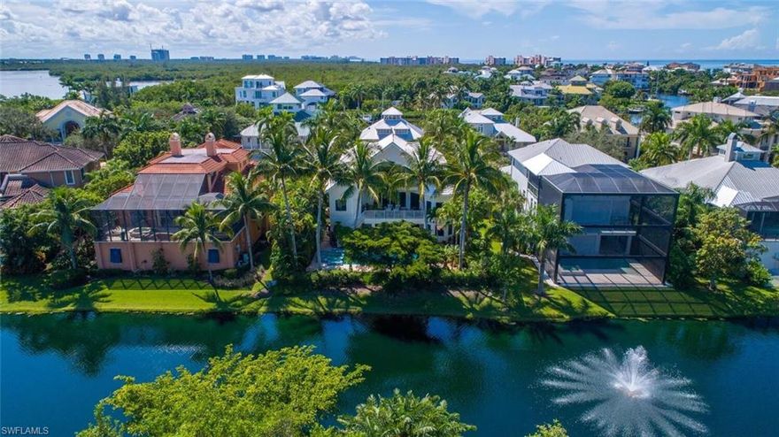 CUSTOM-BUILT BAREFOOT BEACH ESTATE WITH SPECTACULAR WATER VIEW, PRIVATE GULF-ACCESS BOAT DOCK STEPS AWAY & A FEW-MINUTE WALK TO THE BEACH! THE ONLY HOME AVAILABLE IN BAREFOOT BEACH UNDER $5 MILLION! Perfect location on a private, lushly landscaped lot with panoramic lake & preserve views… steps to the Southport Yacht Club with bayfront boat slip #6 included. BEST OF BOTH WORLDS—BEACH & BOATING! The expansive waterfront pool deck is fully fenced with a newly remodeled pool/spa, ample outdoor living space & extra green space- A tropical oasis! This contemporary/transitional home boasts a spacious open floor plan with natural light throughout, high ceilings & fully pocketing sliders for seamless indoor/outdoor living. The luxurious kitchen was renovated in 2017 with custom cabinetry, leathered granite/quartz counters & Thermador/JennAir appliances. Features marble & wood floors, full storm protection throughout, elevator, Lutron light system, surround sound system, central vac & 3 A/C zones.  Perfect location in Southport on the Bay in Barefoot Beach, close to fine dining & easy access to RSW Airport, the Promenade, Mercato & Waterside Shops. Only 15 miles to Naples 5th Avenue.