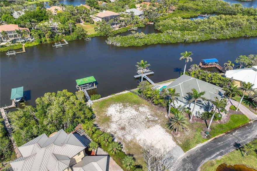 Waterfront lot on Imperial River? Build your dream home. A rare opportunity to own a premier waterfront lot on the picturesque Imperial River, overlooking Bonita Bay. In the sought-after Arroyal subdivision, this exclusive enclave offers privacy and natural beauty, creating the ideal setting for a custom-built estate. This expansive 118-by-330-foot lot provides ample space to design and build a three-story residence, maximizing panoramic water and serene lake views. The property includes a covered 10,000-pound boat lift, offering direct access to the Gulf of Mexico for effortless waterfront living. Just minutes from Bonita Springs' finest dining, shopping and pristine gulf beaches, this lot presents a rare chance to craft a luxury waterfront retreat in an established yet secluded community.