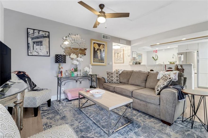 This charming 2-bedroom, 2-bathroom condo is stylishly updated and maintenance free in an ideal location that is both central and serene. The fully equipped kitchen is ideal for hosting friends and family and has recently been updated with a new refrigerator. Relax and enjoy a show on the four ROKU smart TVs, in all of the rooms including the glassed porch. With a new air conditioning system, you'll be cool and comfortable at any time of year. In storm season, you can be worry free with hurricane shutters on all windows. For added convenience, a private laundry room is just a step outside your front door, and you have your own assigned parking space under the carport. Just outside this first floor unit, you can enjoy the community pool area featuring a hot tub, bathrooms, and plenty of space with grills, lounge chairs, and tables. Enjoy the benefits of living on a golf course with the benefit of only paying when you play at Lakewood Country Club. Just outside the peacefulness of the Lakewood community, the best of Naples awaits with groceries and shopping across the street, the USOP Pickleball center within 5 minutes, and vibrant 5th Ave S and Naples famous white sandy beaches 4 miles away. This condo truly delivers the comfort, convenience, and a great location for any lifestyle!