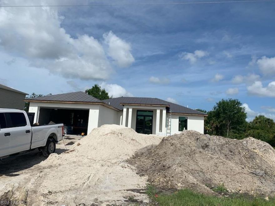 READY JULY 30 !!!   NEW CONSTRUCTION SINGLE FAMILY HOME ON A LARGE LOT WITH NO ASSOCIATION DUES! The home is a 3 bedroom + large den with a closet and 2 designer spacious bathrooms. This home comes standard with a metal roof and impact windows & doors!  Gorgeous contemporary layout w/ open concept kitchen, split bedroom floor plan, luxury plank flooring throughout, quartz countertops, contemporary double door front entry, large slider system on rear of home, laundry room w/ utility sink, volume ceilings, walk-in closet & frameless shower enclosure in master bath, and 2-car garage. You will love this amazing home with top quality construction! .