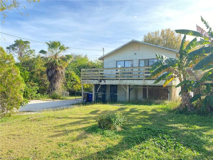 AMAZING LOCATION!! Investors & handymen special. this charming stilt house is in need of attention. The interior is clean and very cute. The exterior has rotted wood and some hurricane damage. The staircase and railing require repairs as well so please use caution when visiting the place. The first story SF can be used as a nice and big storage area. Large fenced yard with room to park RV's , boats, etc.. The house is for sale AS IS. Cash offers only! Great as a rental property or a  flip.