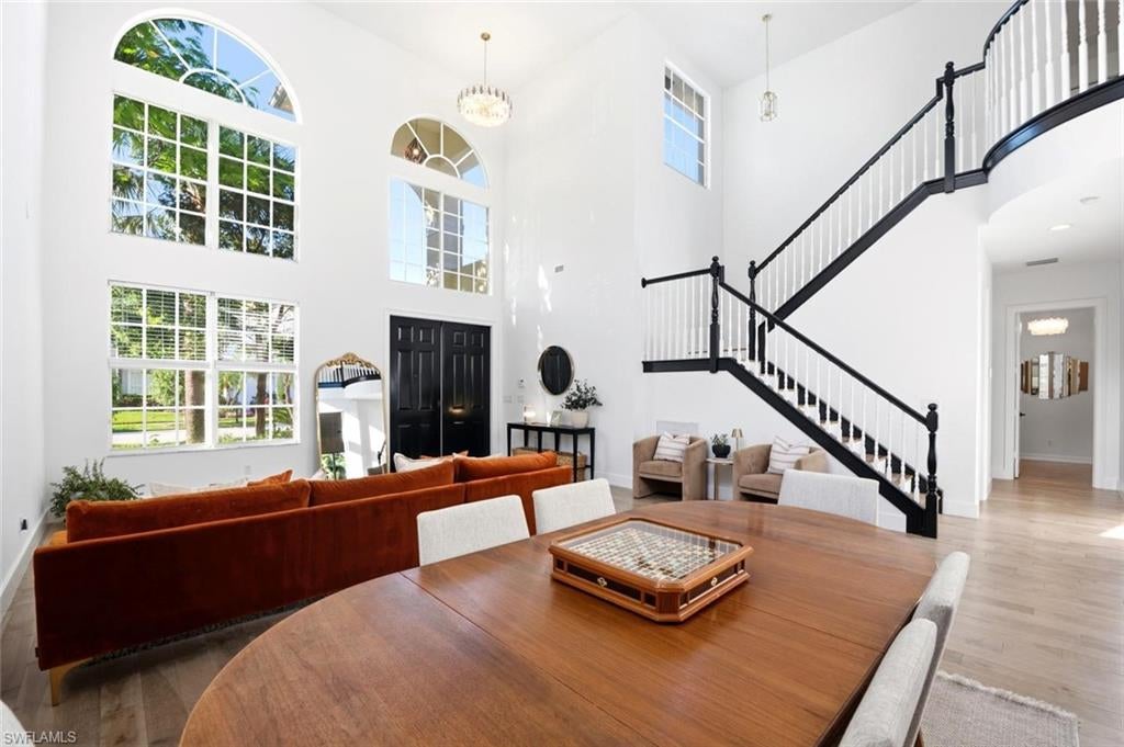Spacious Naples home interior, waterfront views, hardwood flooring, grand staircase, and renovated living spaces.