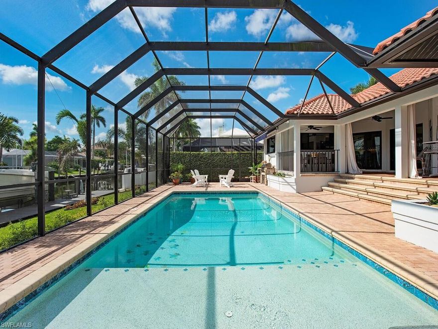 Stunning custom waterfront residence with 80 feet of water frontage in sought-after Royal Harbor. This one-of-a-kind property was completely renovated in 2015 including impact doors and windows and a reinforced seawall. This desirable residence has an open, split-bedroom floor plan, high ceilings, freshly painted cabinetry, an abundance of windows providing plentiful natural light, and a new dock with a 20,000 pound boat lift. Endless upgrades and modern finishes and decor can be found throughout this beautiful home. The outdoor covered living space is built for entertaining complete with outdoor kitchen and living area. The inviting pool, with its own pool bath, is perfect for cooling off on a hot day and the sun shelf allows you to relax on a lounge chair with the water beneath you.  Ideally located just minutes from 5th Ave. South's and 3rd St. South's fine dining, world-class shopping, entertainment and white sand beaches.