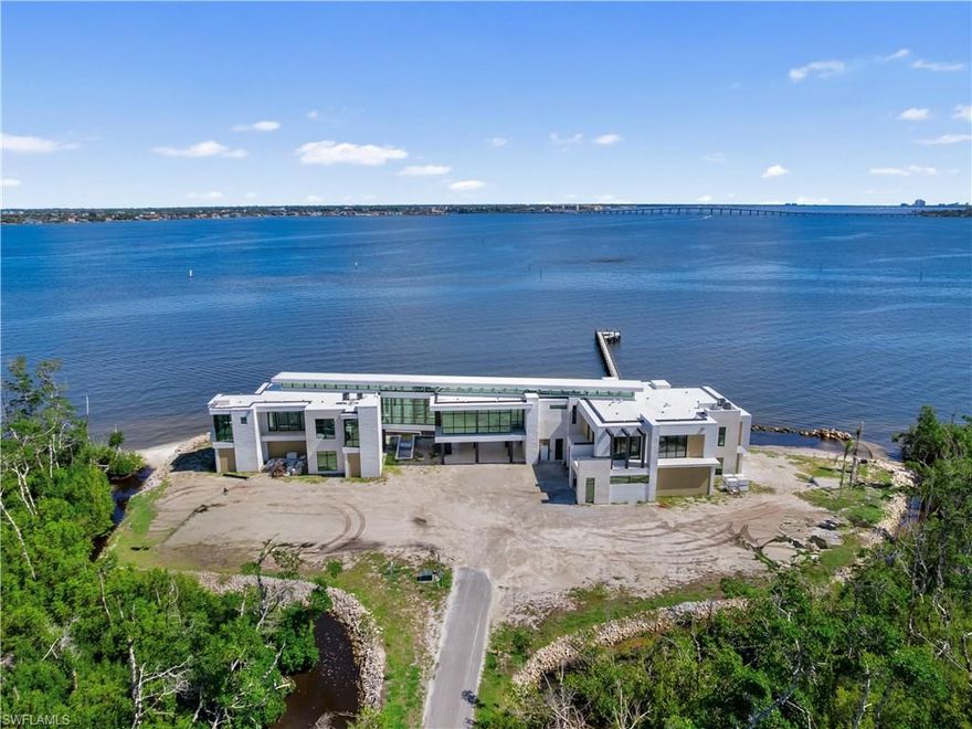 This estate is one of the most amazing luxury estate opportunities ever introduced in Lee County, this extraordinary waterfront property offers the foundation for a truly iconic residence. 31+ acres crowning the most commanding point of a private escape along the Caloosahatchee River. The site boasts over 1,500 feet of shoreline with sweeping water views in both directions and a level of scale, privacy, and natural beauty that is increasingly rare in Southwest Florida. The estate is approached via a private, gated entrance and a 1,500-foot drive, winding through mature tropical foliage and tidal inlets that naturally buffer the property from the outside world. The setting was carefully selected for those whose lifestyle demands absolute privacy, security, and discretion, while still offering direct access to open water, nearby islands, and regional ports. Designed as the future home of architectural significance, the property supports a residence of substantial scale and presence, with site planning that maximizes water frontage, view corridors, and the daily movement of light across the landscape. A 380-foot dock near the mouth of the river provides exceptional boating access, while the expansive acreage allows for additional features such as guest structures, recreational amenities, or aviation accommodations, including a potential helipad-ready site. This is not simply a homesite, it is a legacy property, offering a rare opportunity to create an estate of enduring value on one of the most compelling waterfront parcels in the region.