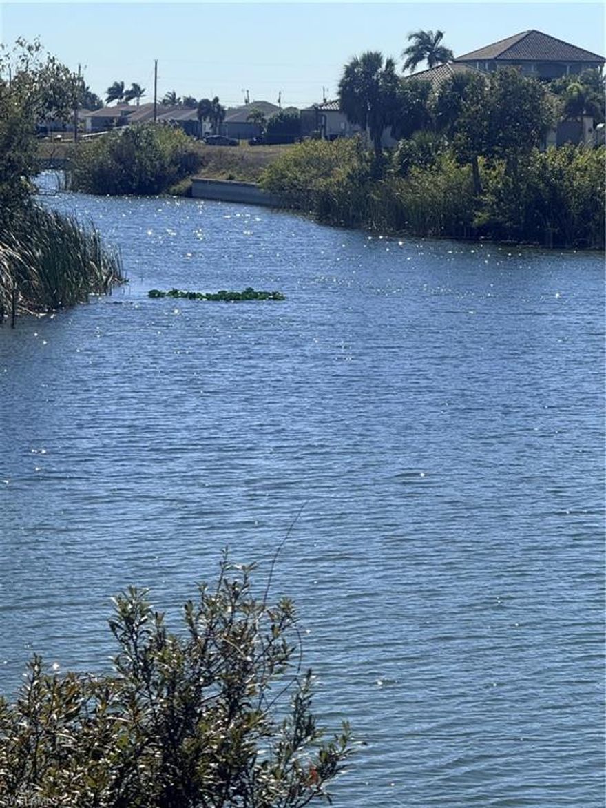 Build your dream home on this .33-acre oversized, pie-shaped basin lot in Cape Coral with scenic views of the Zanzibar and Frontier canals. This property is part of the City’s freshwater canal system, offering access through connected waterways to multiple freshwater lakes, including Anchor Lake, Pelican Lake, and several others—ideal for kayaks, paddleboards, small boats, and pontoons (no Gulf access).  The lot is in a No Flood Zone and sits approximately 2+ feet above street level, which may help reduce future build costs. An active burrowing owl burrow is located along the front/side portion of this lot and partially on the neighboring vacant lot. A great opportunity for a larger waterfront homesite with intersecting canal views and added privacy.