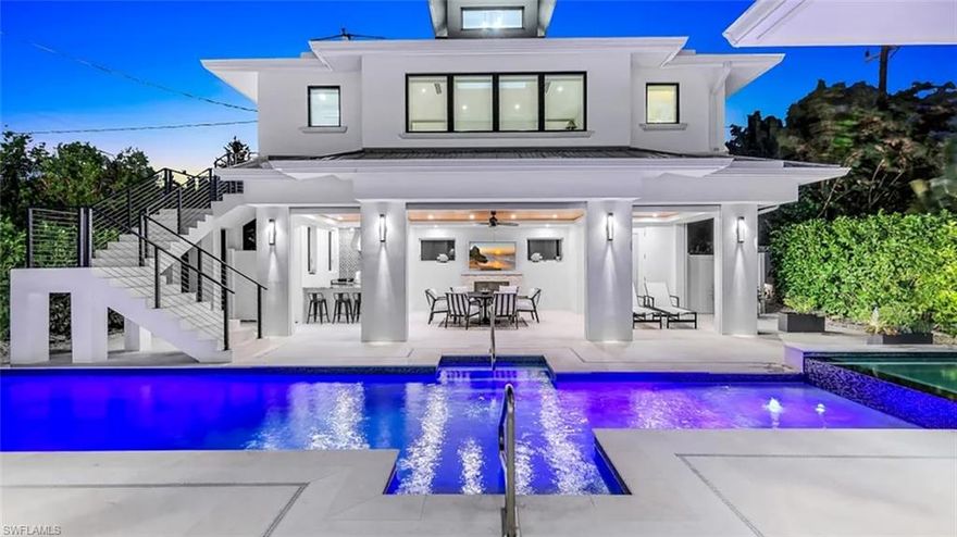 Also available as an annual. Nestled in prestigious and highly sought-after Old Naples, this exceptional five bedroom, five and a half bath residence offers the ultimate in coastal luxury. Spanning over 5,800 square feet of thoughtfully designed living space—including a private guest cabana—this home impresses from the moment you arrive. A brick-paver circular driveway and elegant French doors set the stage for the refined details found throughout. The stylish living room features leather furnishings, an open-concept layout, and expansive sliding glass doors that lead to a serene outdoor oasis. The chef’s kitchen is impeccably appointed with top-of-the-line amenities, including a large island with seating for six and an integrated dishwasher, wall oven, spacious gas range, and abundant storage. The elegant dining room, highlighted by a striking chandelier, comfortably seats six and is ideal for entertaining. A dedicated wine room provides ample space for your favorite vintages. The first-floor primary suite is a private retreat, offering a plush king-sized bed, abundant natural light, and beautiful beamed ceilings. The spa-inspired primary bath features a walk-in shower and a luxurious soaking tub. Upstairs, a versatile loft provides additional living space, while three well-appointed ensuite bedrooms each offer queen-sized beds and private baths. Just outside sits a private guest cabana with a sleeper sofa and shower. A resort-style pool area complete with an outdoor bar and kitchen, fireplace, and TV, all surrounded by lush landscaping that creates a secluded, fully fenced sanctuary. Perfectly located just moments from the world-class dining and shopping of iconic Fifth Avenue, this home embodies coastal living at its finest. Live exceptionally in Old Naples.