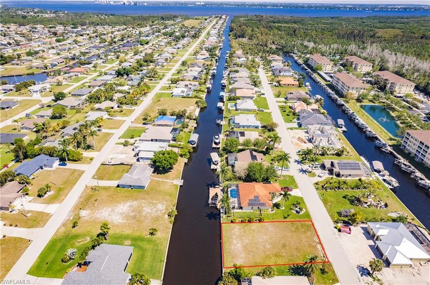 This vacant lot offers a rare opportunity to build your dream waterfront oasis in one of Southwest Florida's most desirable locations. Situated on a generously sized 0.24-acre parcel, this fully cleared lot has breathtaking waterfront views without the hindrance of bridges, ensuring seamless access to open waters and the Gulf of Mexico. Whether you're an avid boater or simply crave the tranquility of waterfront living. 
Located in a serene and peaceful neighborhood, surrounded by million-dollar homes, privacy and exclusivity are paramount. Property has fill city utility services Water and Sewer and is fully paid off!