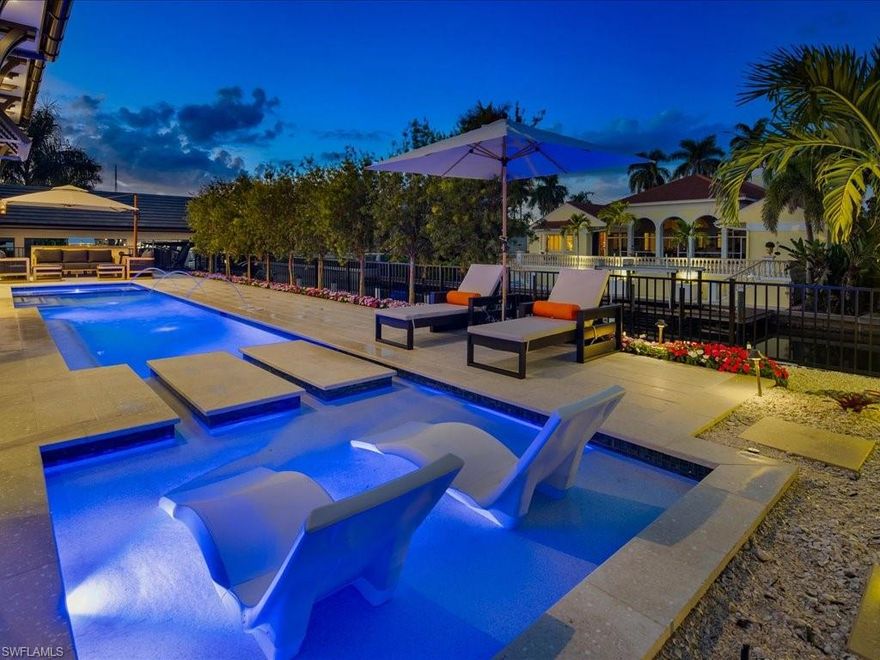 Poised along one of Aqualane Shores’ most prestigious waterfront avenues, 425 15th Avenue South presents a newly constructed architectural statement where bespoke design and effortless coastal elegance converge. Crafted by Lotus Construction and thoughtfully envisioned by Lisa Ficarra, this exceptional residence spans over five thousand eight hundred square feet under air, revealing a level of refinement that is both understated and unforgettable. From the moment of arrival, interiors unfold into a luminous great room defined by soaring ceilings, Legno Bastone European oak flooring, and walls of glass that open through twelve-foot sliders, dissolving boundaries and welcoming warm Gulf breezes. Designed for seamless entertaining, the home flows effortlessly to its outdoor living spaces, where a resort-style setting invites both intimate evenings and grand gatherings. At the heart of the residence, the chef’s kitchen is a true work of art, showcasing handcrafted Ruffino cabinetry and an elite suite of Wolf, Sub-Zero, and La Cornue appliances—an environment equally suited to casual mornings and elevated culinary experiences. The primary suite offers a serene retreat, designed with a spa-like sensibility and impeccable attention to detail. Outdoors, a private waterfront sanctuary awaits, complete with a boathouse and direct Gulf access for effortless days on the water and spontaneous sunset cruises. Elevated construction, full Control4 integration, and a rare five-car garage further distinguish this offering. Just moments from the boutiques and dining of Third Street South and Naples’ pristine shoreline, this residence embodies the pinnacle of waterfront living—an extraordinary opportunity to experience the very best of Naples. NOTE: A limited number of strategic stone block walls from the original 1998 construction were intentionally retained to preserve grandfathered rights associated with the existing boat dock and to maintain the pool at its original elevation aligned with the first floor. These preserved elements significantly enhance the property’s overall value by allowing continued use of these high-demand waterfront amenities under prior regulations that might otherwise not apply. The property received its Certificate of Completion in 2025, confirming that all new improvements were completed in full compliance with the approved plans and specifications.