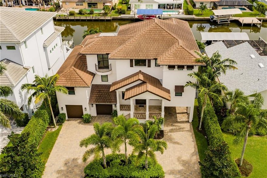 Don't miss out on this 2015 custom built waterfront home available in Conners Vanderbilt Beach.  With 4 bedrooms + den, 3 full baths, 5 car garage, elevator, and 3649 square feet of living space and 7254 total square feet, this Coastal Transitional residence is filled with exceptional finishes throughout, shows impeccably, and offers premium southern exposure on a direct Gulf access canal.  The two story great room offers wide canal views with custom fireplace. The beautiful kitchen features a large island, walk-in pantry, and custom cabinetry with Wolf and Sub-Zero appliances.  This home includes a Savant System, allowing for a premium smart home experience.  TV's, lighting, whole home audio, and climate controlled from a single phone app or remote. The expansive outdoor living space includes an outdoor kitchen, two tv's, pool with spa, and balcony off of the master suite with amazing sunset views.  The 45x19 boat dock features two lifts and offers direct Gulf of Mexico access! One lift will fit up to a 30 ft boat and the second lift fits two wave runners.  Conveniently located close to upscale shopping and the areas finest restaurants.