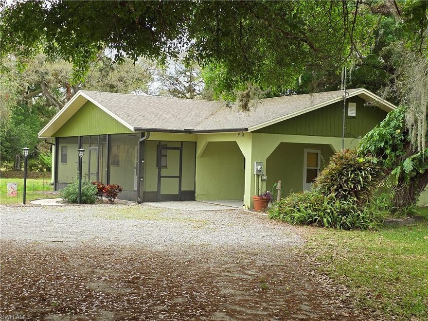 Located in one of the most desirable areas of LaBelle/Ft. Denaud, just minutes from Alva, this spacious home offers comfort, functionality, and privacy. The layout features a generous kitchen, a flexible den or formal dining area, a separate living room, large laundry room, and well-sized bedrooms. Enjoy relaxing mornings or evenings on the expansive screened front porch. Tucked away in a picturesque setting, this property offers peaceful living—and best of all, it is not located in a flood zone