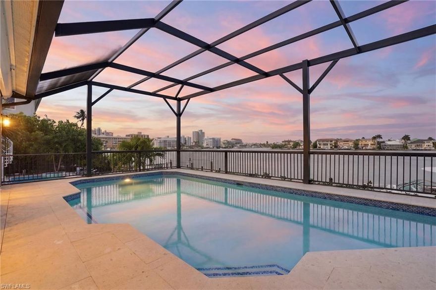 The one you have been waiting for…a true waterfront standout that checks every box—and notably, remained high and dry with no water intrusion into the living spaces from any past storms, offering a rare level of confidence and peace of mind in a bayfront setting.

Enjoy breathtaking, panoramic bay views from this beautifully renovated, fully furnished two-story residence offering 5 bedrooms, 3.5 baths, and the ultimate Naples waterfront lifestyle. Perfectly positioned to capture wide-open water vistas, this home blends thoughtful upgrades with timeless coastal elegance.

Extensively improved and meticulously maintained, the property features a newer dock and seawall (2017, Nelson Marine), along with a private composite wraparound boat dock and electric lift, making it ideal for effortless Gulf access and sunset cruises. Major mechanical and structural updates provide exceptional peace of mind, including a new roof (2019, King Roofing), hurricane impact windows and front door (2020, Guardian Hurricane), electric hurricane shutters for the lanai, full home re-pipe and new water heater (2024, Pro-Tec Plumbing), pool renovation with all new equipment (2025), new screen enclosure (2025), new gutters (2026), and an epoxy-coated garage floor (2026). Termite bond in place with Terminix.

Inside, refined finishes and a clean, coastal palette define the living spaces. The first floor showcases stunning textured tile flooring, while the second level offers soft neutral carpeting. Custom crown, base, and window moldings, designer lighting, ceiling fans, and plantation shutters elevate the home throughout.

The chef’s kitchen is both functional and beautifully appointed, featuring Silestone countertops and backsplash, accent glass tile, a breakfast bar and nook, and premium built-in appliances including a large JennAir refrigerator, glass cooktop, Thermador range, dishwasher, and stainless sink.

The primary suite is a private retreat with direct lanai access, a spacious walk-in closet, and a spa-inspired bath complete with dual vanities, a makeup station, soaking tub, and oversized walk-in shower.

Upstairs, two additional bedrooms—including one with a built-in wet bar—open to an expansive open-air balcony, offering yet another vantage point to take in the sweeping bay views. Additional highlights include a dedicated laundry room with sink and storage, a two-car attached garage, and a screened lanai centered around a freshly resurfaced and upgraded pool area—perfect for entertaining or relaxing in the Florida sun.

Ideally located just moments from the Ritz-Carlton, the new Ritz-Carlton Residences, and the sugar sand beaches of Vanderbilt Beach, with easy access for walking or biking. A rare opportunity to own a fully updated, move-in-ready bayfront home with exceptional outdoor living, boating capabilities, and proven storm resilience.