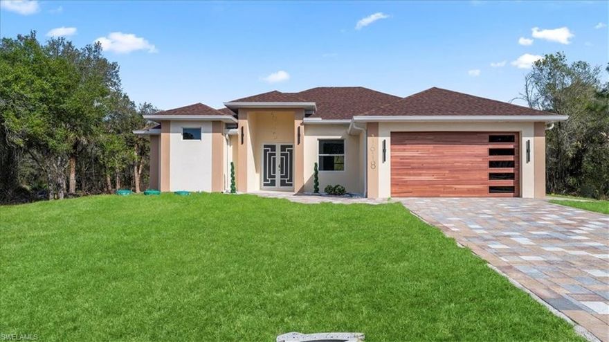 Stunning new construction in Lehigh Acres featuring 3 bedrooms plus a den and 3 full bathrooms, thoughtfully designed and situated on a spacious half-acre lot.

This home showcases luxury finishes throughout, offering a perfect blend of elegance and functionality. It includes impact-resistant doors and windows for added security and energy efficiency. The modern kitchen is equipped with a built-in oven and microwave, cooktop, and range hood, complemented by upscale finishes that elevate the overall design.

The property also features an automatic sprinkler system to keep the landscaping looking its best year-round.

Enjoy exceptional outdoor living with a spacious covered lanai that includes a fully equipped outdoor kitchen — ideal for entertaining. The oversized backyard provides plenty of room to add a pool or create your own private outdoor oasis.

Located in a non-flood zone, this home offers peace of mind and eliminates the need for flood insurance. With no HOA and no restrictions, you have the flexibility to truly enjoy your property.

Seller is offering buyer assistance, making this an excellent opportunity to own a brand-new home with luxury finishes, space, privacy, and modern features in one of Lehigh Acres’ fastest-growing areas.