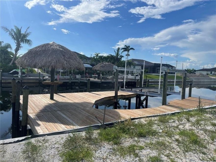 Build your dream home on this exceptional Gulf access lot in Cape Coral and enjoy the very best of Southwest Florida waterfront living. Nestled in a quiet, upscale neighborhood surrounded by beautiful newer homes, this prime waterfront property offers direct boating access from a wide, navigable canal, making it a rare opportunity for boaters, anglers, and anyone seeking the ultimate Florida lifestyle. Already improved with a brand-new seawall, private boat dock, and 10,000-pound boat lift, this lot is ready for your custom waterfront retreat.
Imagine stepping out your back door and heading straight to island dining, sunset cruises, and world-class fishing in the Gulf of Mexico. Whether you're an avid boater or simply love the peaceful beauty of waterfront living, this property delivers the perfect setting to create your own private paradise. Adding even more charm is a tropical tiki hut, the ideal place to relax with a drink, enjoy the coastal breeze, and take in serene canal views.
Conveniently located near Kismet Lakes, Coral Oaks Golf Course, shopping, dining, parks, and everyday conveniences, this homesite offers the perfect blend of luxury, recreation, and accessibility. With its outstanding location, valuable waterfront improvements, and direct Gulf access, this is an incredible opportunity to build in one of Cape Coral’s most desirable areas.