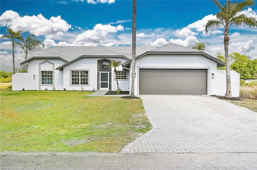 Welcome to this Stunning renovated Pool home in Lehigh Acres. Huge property with 3 bedrooms+ den, 3 bathrooms and 2 car garages. Very rare opportunity with 2 primary suites with Pool bath and one of the kind huge outdoor pool area! The property has been totally renovated from top to bottom, Step inside, you'll be greeted by stunning wood plank tile that graces the entire house with 5 inches base board gives it the modern feel. The living room, open concept with kitchen and dining area offers great practical space for family and friends gathering and partying. Nice den/office in the front of the home give it much needed separation for all the work to be done. This luxury kitchen carries brand new hardwood cabinets with soft closing features, beautiful calacatta quartz countertop with waterfall, up to the ceiling backsplash with floating shelve, not to mention 2 huge pantries just off the kitchen and  brand-new stainless-steel appliances. Step inside the huge primary bedroom with vaulted ceiling and the one of the kind spas like primary bathroom literally take your breath away when you step in. The shower and tub area is the largest I have ever seen. Every bedroom is very large along with second primary tuck away that comes with the pool bathroom. Home has brand-new LED lighting throughout the entire house. Property is in X zone, so you don’t have to worry about flood insurance. Perfect screen in cage with large cover area oversees practical backyard and lake provides endless Florida outdoor living lifestyle with privacy. This is a very rare large property with 2 primary suites and pool bathroom with a huge outdoor patio area. You do not want to miss this one of the kind properties