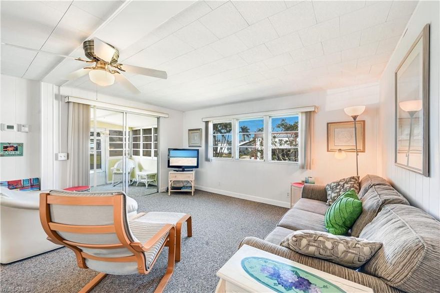 Owner is motivated. Move-in ready. 11 Moonstone Cir.  This double wide mobile with 2 bedroom, 1 and 1/2 bathrooms, has a Florida room in the front and part of the carport was screen-in in to create an outdoor patio. Being sold as turnkey furnished with a few exceptions.  Located in the Enchanting Acres Mobile Home Park on a cul-da-sac. Enchanting Acres is a 55 plus in age community, coop ownership, Community Pool, Club House, and Shuffle board. Located close to Bayshore Arts District, 5th Avenue South and 3rd Street South, Publix across the street from community along with restaurants, movie theater. Sugden Park is just down the street. Don't miss this opportunity to Live in the Paradise Coast of Florida.