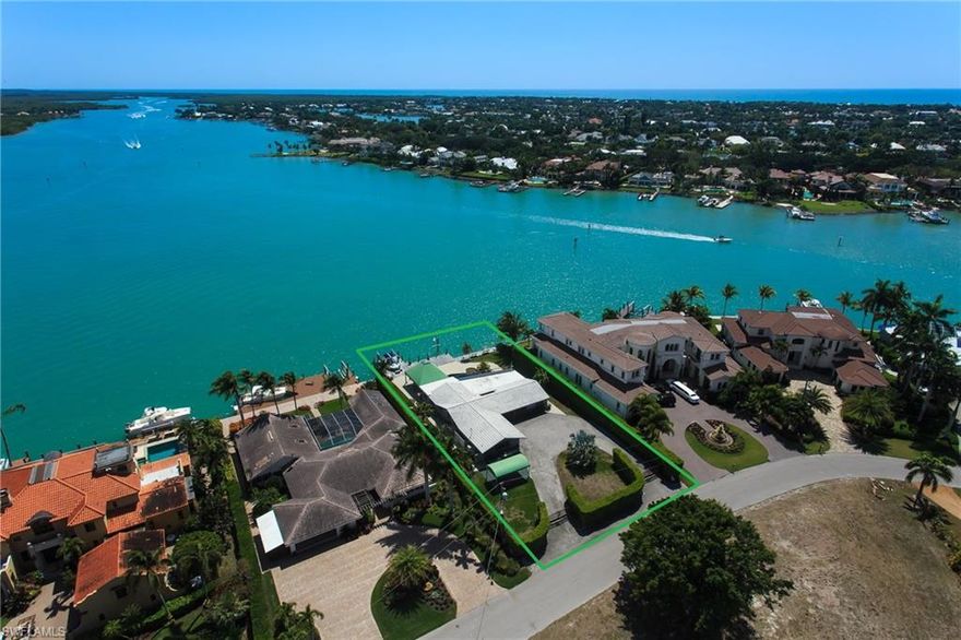 H.11826 AMAZING, NEVER ENDING VIEWS OF THE INTER-COASTAL! Build your dream home on this gorgeous, over-sized, bay front lot with southern exposure and stunning, panoramic views!  Watch the dolphins play every morning from current 3 bedroom, 3 bathroom, ranch style home with lagoon style pool and waterfall.  This is one of the most desirable lots in all of Naples; perfectly located just minutes from Naples Bay with direct access to the Gulf of Mexico.