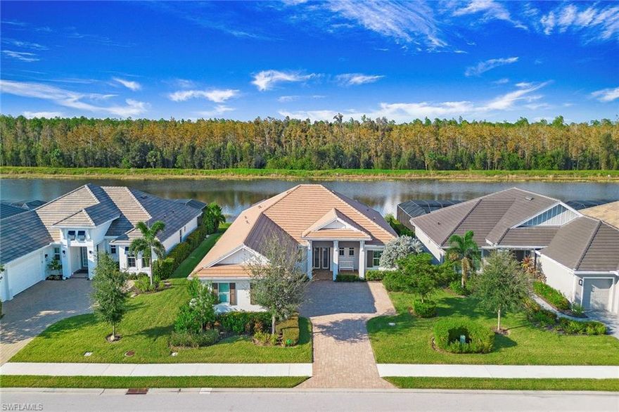 Set along the private rowing lane in the sought-after community of Naples Reserve, this beautifully appointed Stock Development residence enjoys tranquil water and protected preserve views, offering a serene backdrop for everyday living. Thoughtfully upgraded throughout, the home features three bedrooms plus a den (easily converted back to a fourth bedroom), three baths, and 2,445 square feet of light-filled living space. Inside, tile flooring flows seamlessly throughout the home, complemented by designer lighting and Hunter Douglas custom window treatments with PowerView automation. The well-appointed kitchen showcases quartz countertops, a tile backsplash, walk-in pantry with custom California Closets shelving, and a suite of KitchenAid appliances including induction cooktop, wall oven, microwave/speed oven, warming drawer and refrigerator.  The primary suite provides a private retreat with dual vanities, quartz countertops, a floating soaking tub and a spacious custom closet system by California Closets. Impact-resistant windows and sliders offer comfort and peace of mind. Outdoor living is designed for the Southwest Florida lifestyle, featuring a heated pool and spa, upgraded pool tile, picture-frame lanai screen, and Storm Smart electric roll-down hurricane screens that create a seamless transition between indoor and outdoor spaces. Additional highlights include a three-car garage with epoxy flooring and air-conditioned mini-split, whole-house Generac generator (2024) powered by a 500-gallon buried propane tank, custom California Closets throughout and extensive storage. Residents of Naples Reserve enjoy a vibrant resort-inspired lifestyle centered around Eagle Lake, with amenities that include a lakeside clubhouse, resort-style pool, fitness center, tennis and pickleball courts, walking trails, beach area and waterfront dining, all just minutes from the shopping, dining and white sand beaches of Naples.