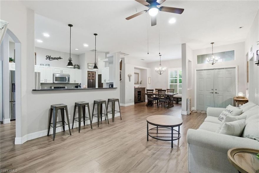 Fall in love with this charming Valencia Lakes home! This inviting residence in the fabulous, gated community of Valencia Lakes features 4 spacious bedrooms, 2 bathrooms, and a 2-car garage. Enjoy peaceful lake views from the extended lanai and unwind in the hot tub - an ideal setting to relax or entertain. Inside, a bright open-concept layout with volume ceilings creates an airy, inviting feel. The open kitchen is perfect for entertaining and enjoying with family. Boasting white cabinetry, elegant black granite counters, stainless steel appliances and newer pendant lighting. NEWER ROOF, at just 5 years new (2020), providing added peace of mind. The coveted gated community of Valencia Lakes offers its residents a resort-style pool, fitness center, pickle ball, tennis court and basketball, all with low HOA fees. Ideally located in prime Golden Gate Estates location, this home is just 3 mins. from both the Publix Shopping Center and the new Shops at Randall. Additionally, it is a quick 8 min. drive to the newest regional park in Naples, Big Corkscrew Island Regional Park. Come see why this home, and this amenity-rich community are truly a Naples gem!